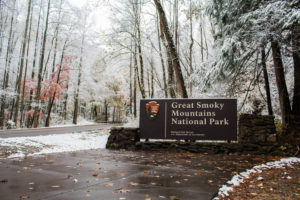 great smoky mountains national park sign with snow